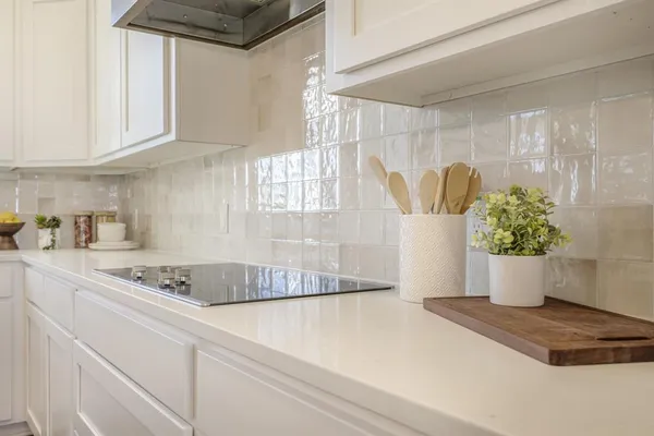 a view of kitchen with stainless steel appliances granite countertop a sink a stove and a window