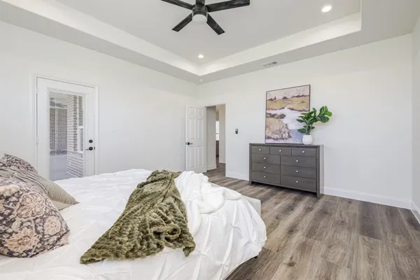 a bedroom with a bed and a painting on the wall