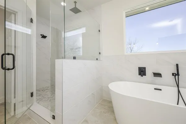 a bathroom with a bathtub and a shower