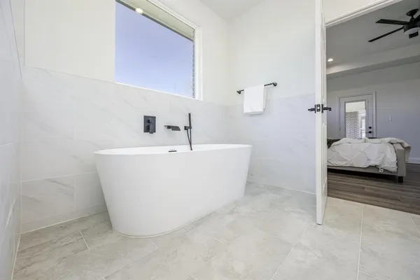 a view of a bathtub & sink in a bathroom