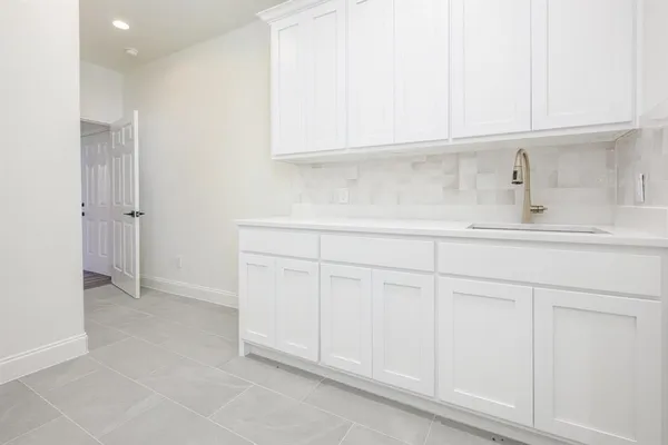 a kitchen with white cabinets