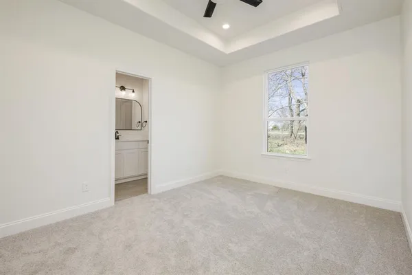 an empty room with windows and cabinet