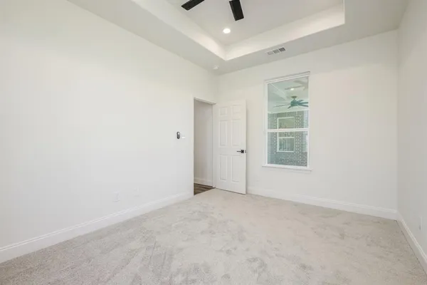 an empty room with windows and closet