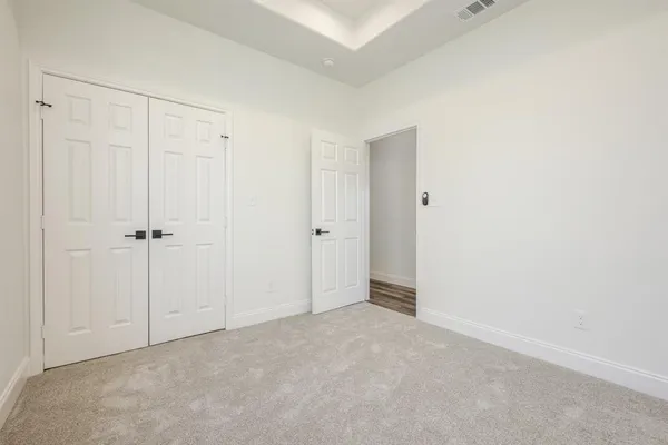 an empty room with white cabinet