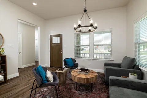 a living room with furniture and a chandelier