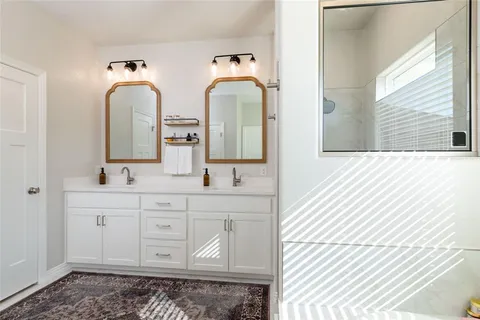a bathroom with mirror a sink and a mirror