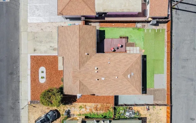 an aerial view of a house with a backyard space