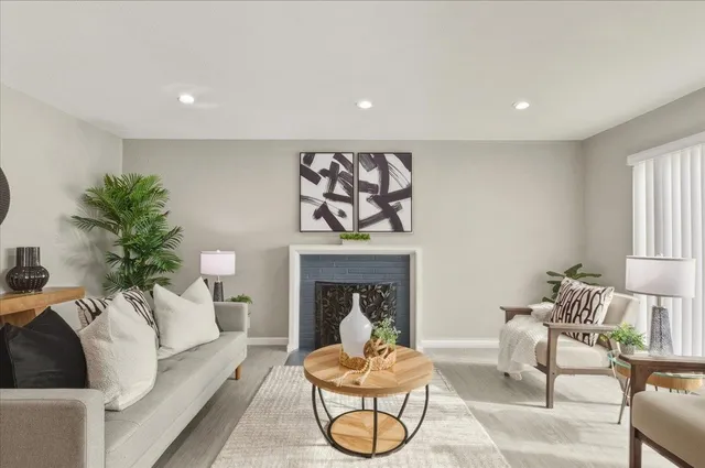 a living room with furniture and a fireplace