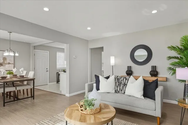 a living room with furniture and a wooden floor
