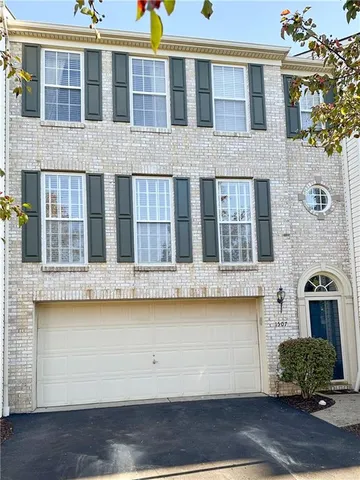 a front view of a building with a garden