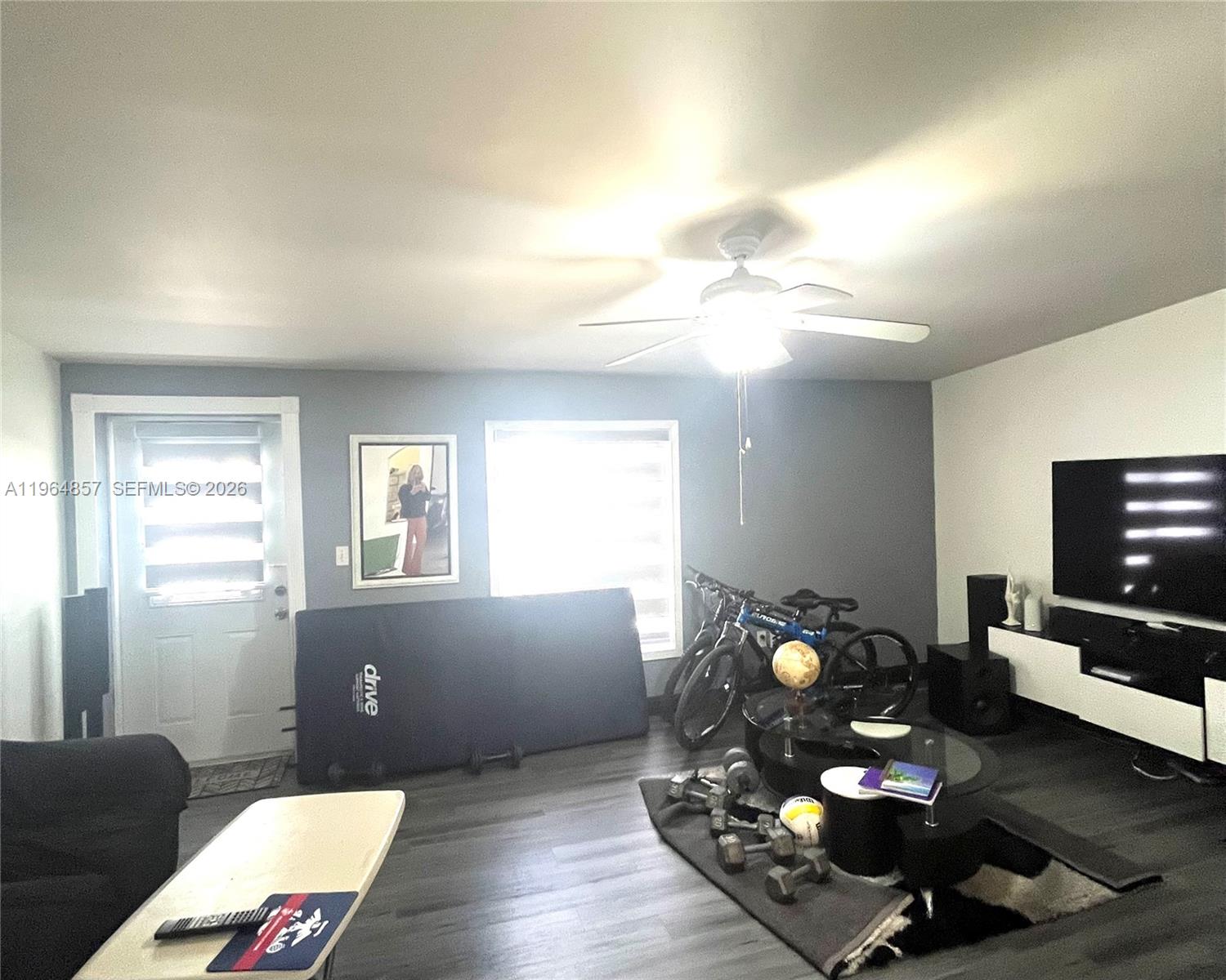 12271 Southwest 187th Street Miami, FL 33177 - Photo 11 of 27 a living room with furniture and a flat screen tv