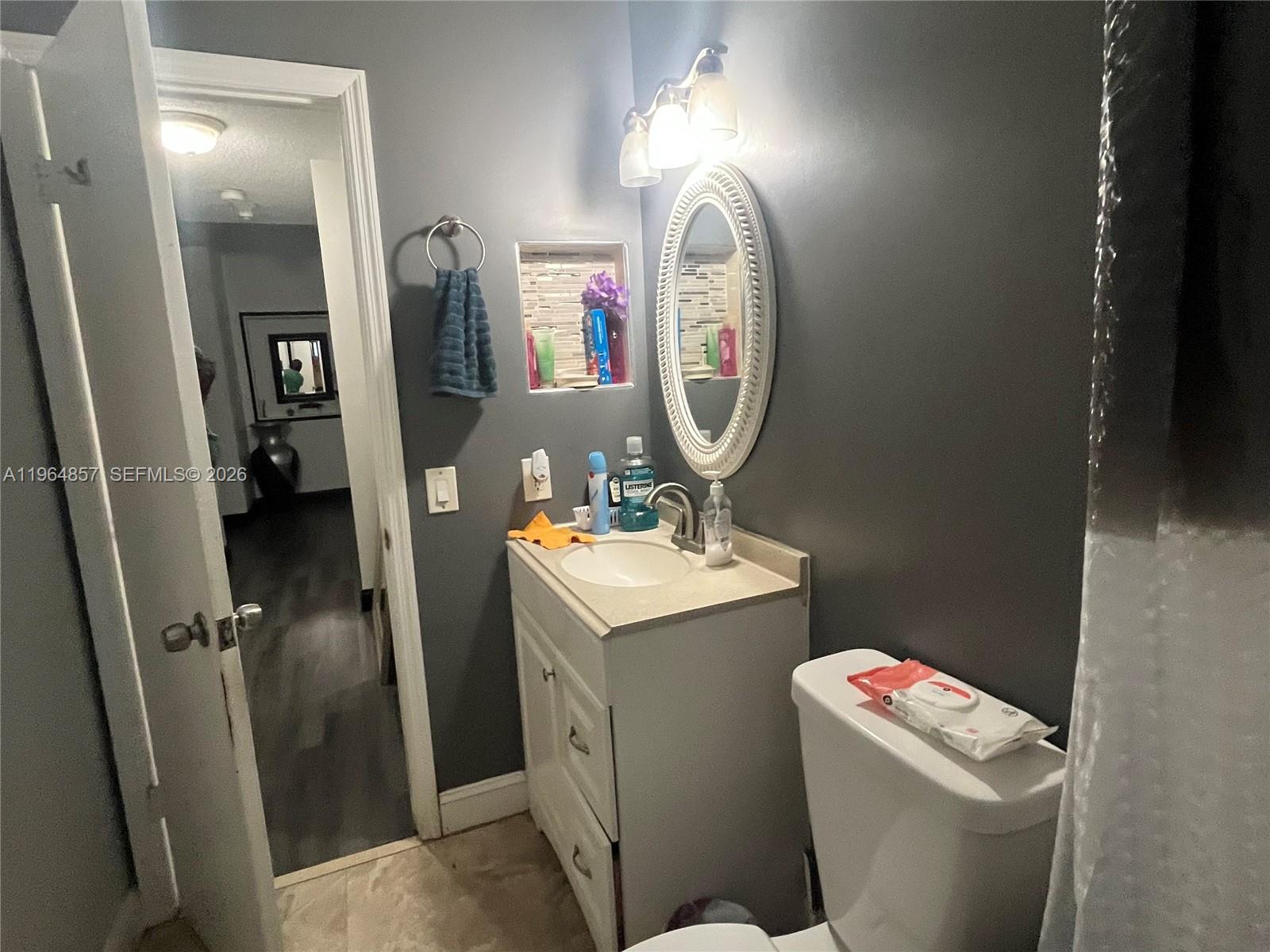 12271 Southwest 187th Street Miami, FL 33177 - Photo 15 of 27 a bathroom with a toilet sink and mirror