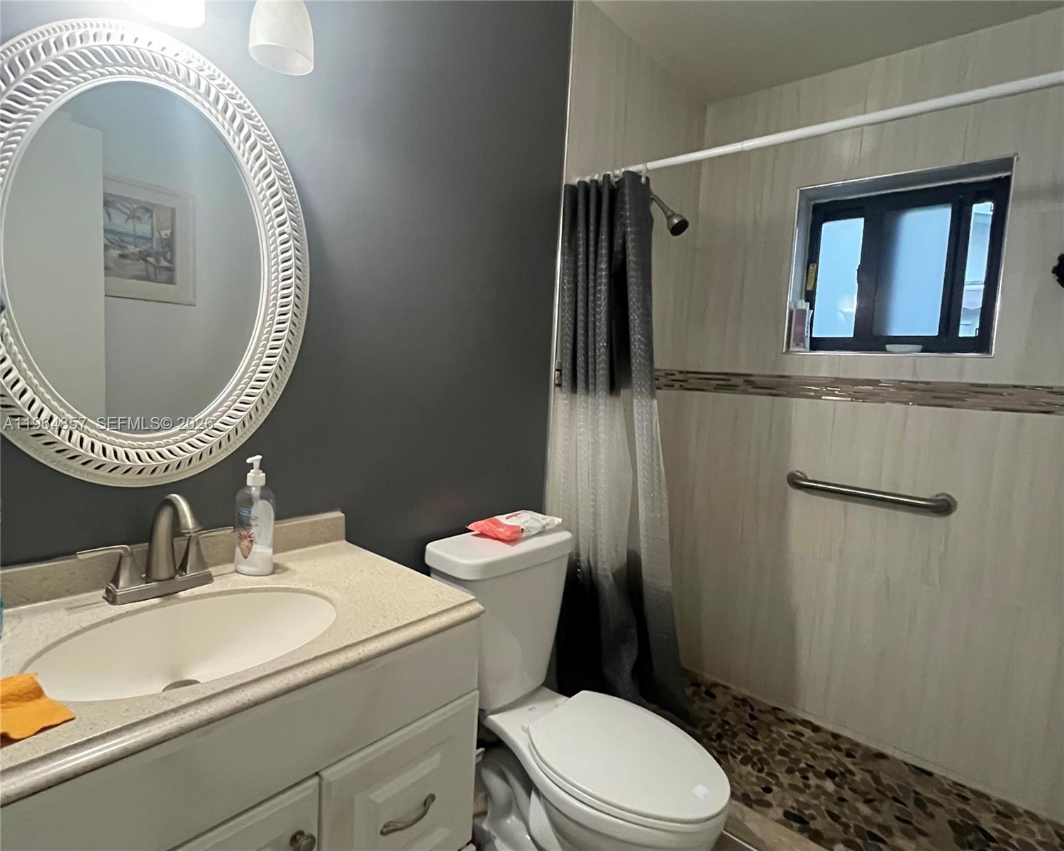 12271 Southwest 187th Street Miami, FL 33177 - Photo 16 of 27 a bathroom with a sink mirror vanity and toilet