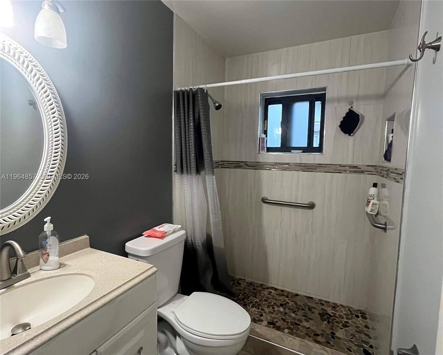12271 Southwest 187th Street Miami, FL 33177 - Photo 17 of 27 a bathroom with a toilet a sink and mirror