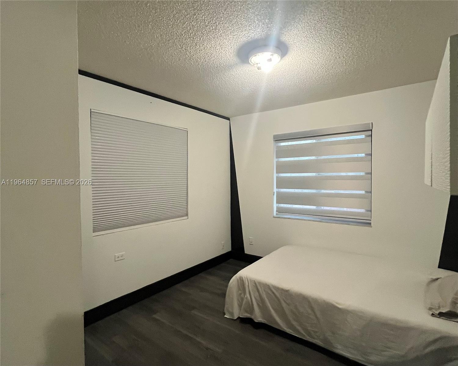 12271 Southwest 187th Street Miami, FL 33177 - Photo 18 of 27 a bedroom with a bed and a window