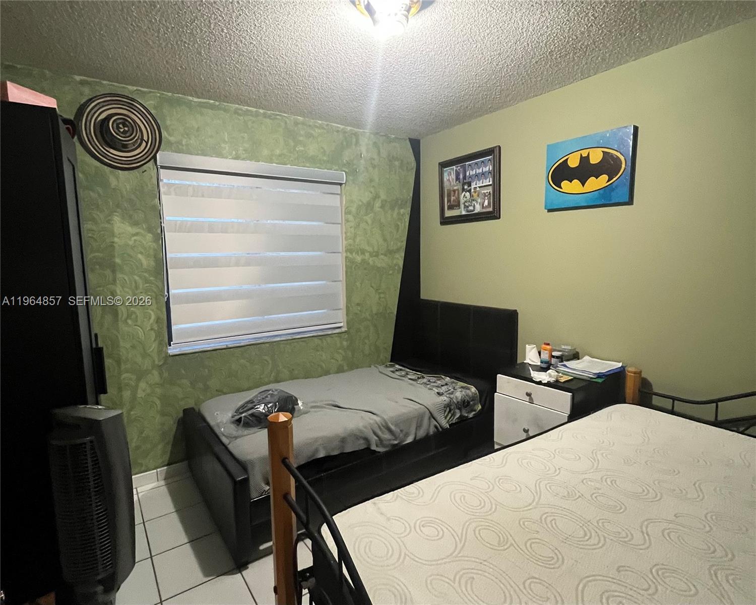 12271 Southwest 187th Street Miami, FL 33177 - Photo 20 of 27 a bedroom with two beds and a window