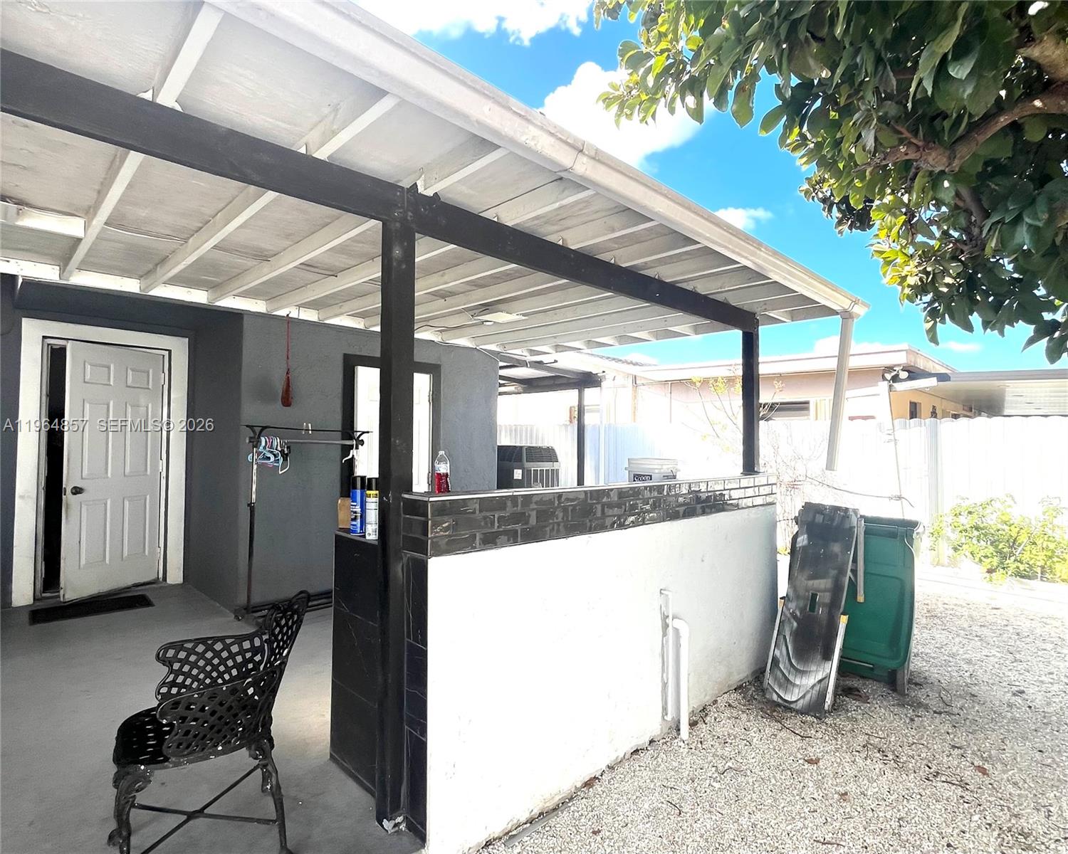 12271 Southwest 187th Street Miami, FL 33177 - Photo 23 of 27 a view of a patio with a dining table and chairs