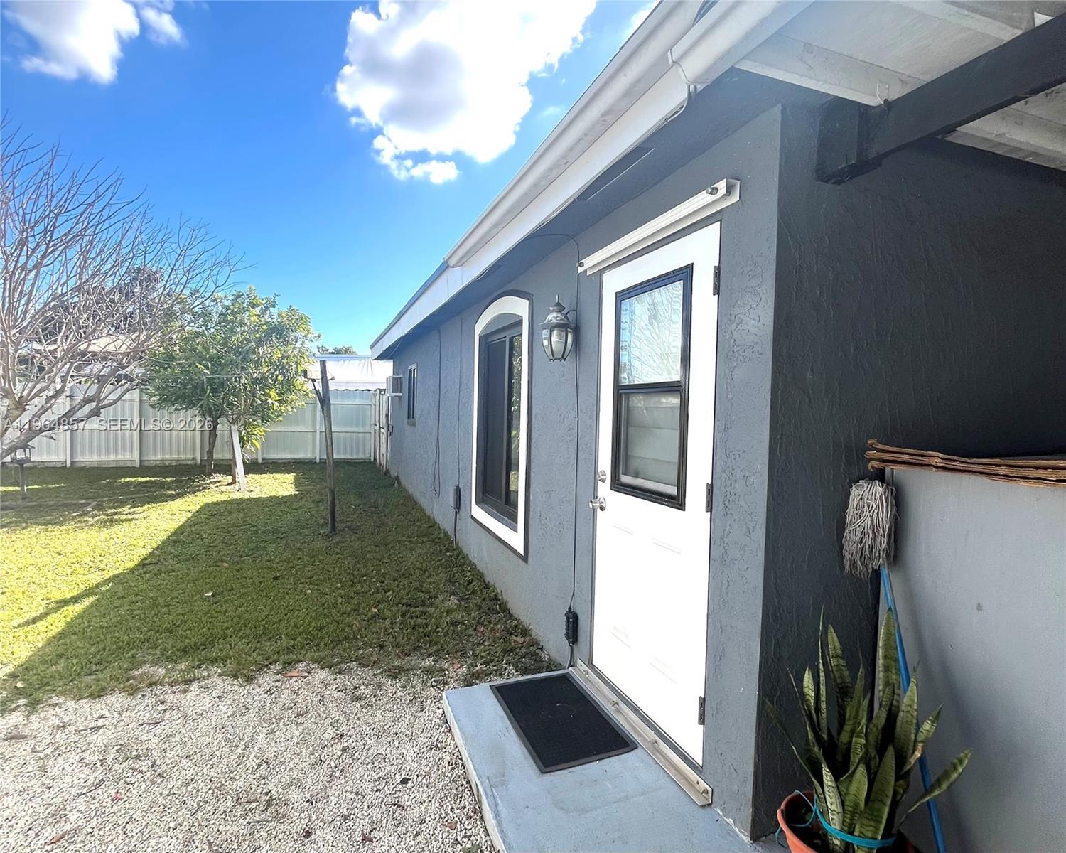 12271 Southwest 187th Street Miami, FL 33177 - Photo 24 of 27 a front view of a house with garden