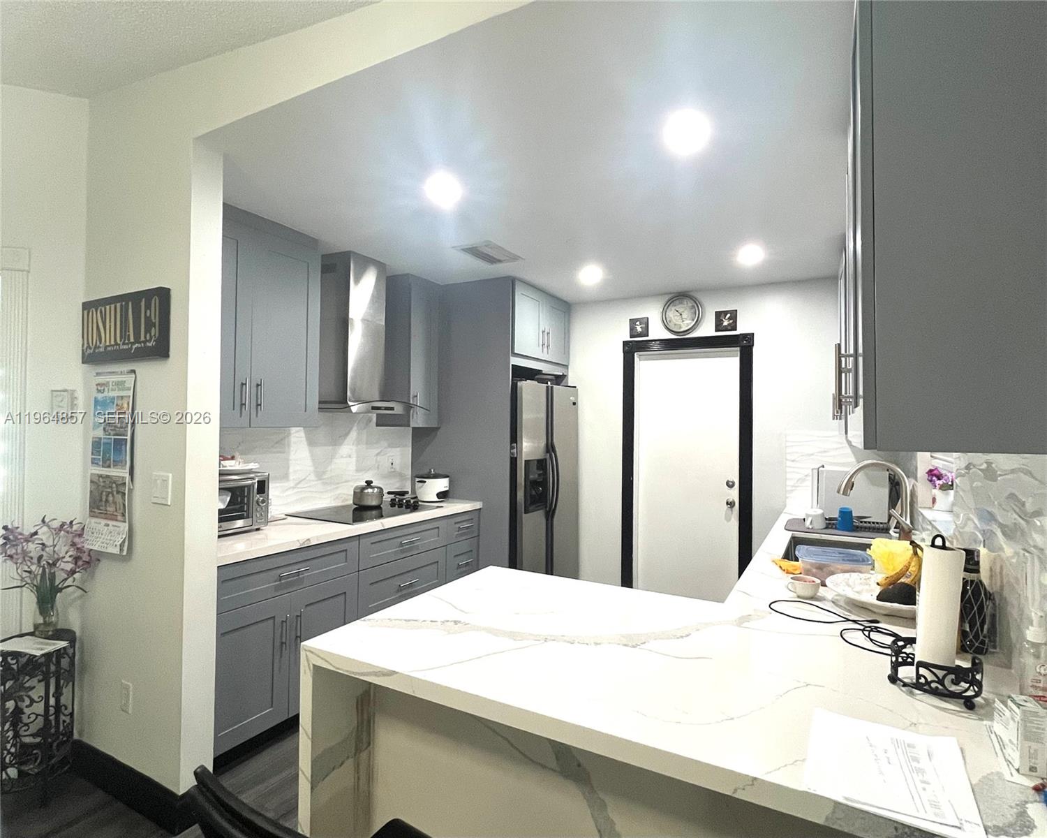 12271 Southwest 187th Street Miami, FL 33177 - Photo 10 of 27 a kitchen with a sink a stove and refrigerator