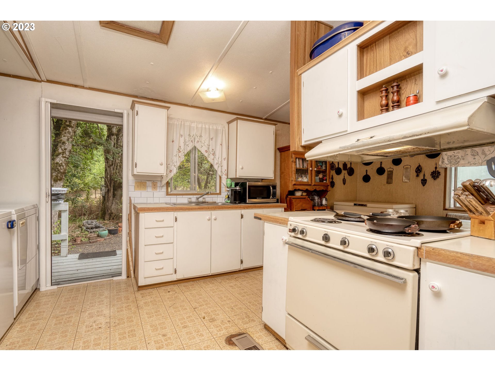 26720 Northwest Williams Canyon Road Gaston, OR 97119 - Photo 21 of 33 a kitchen with stainless steel appliances granite countertop a stove and a cabinets