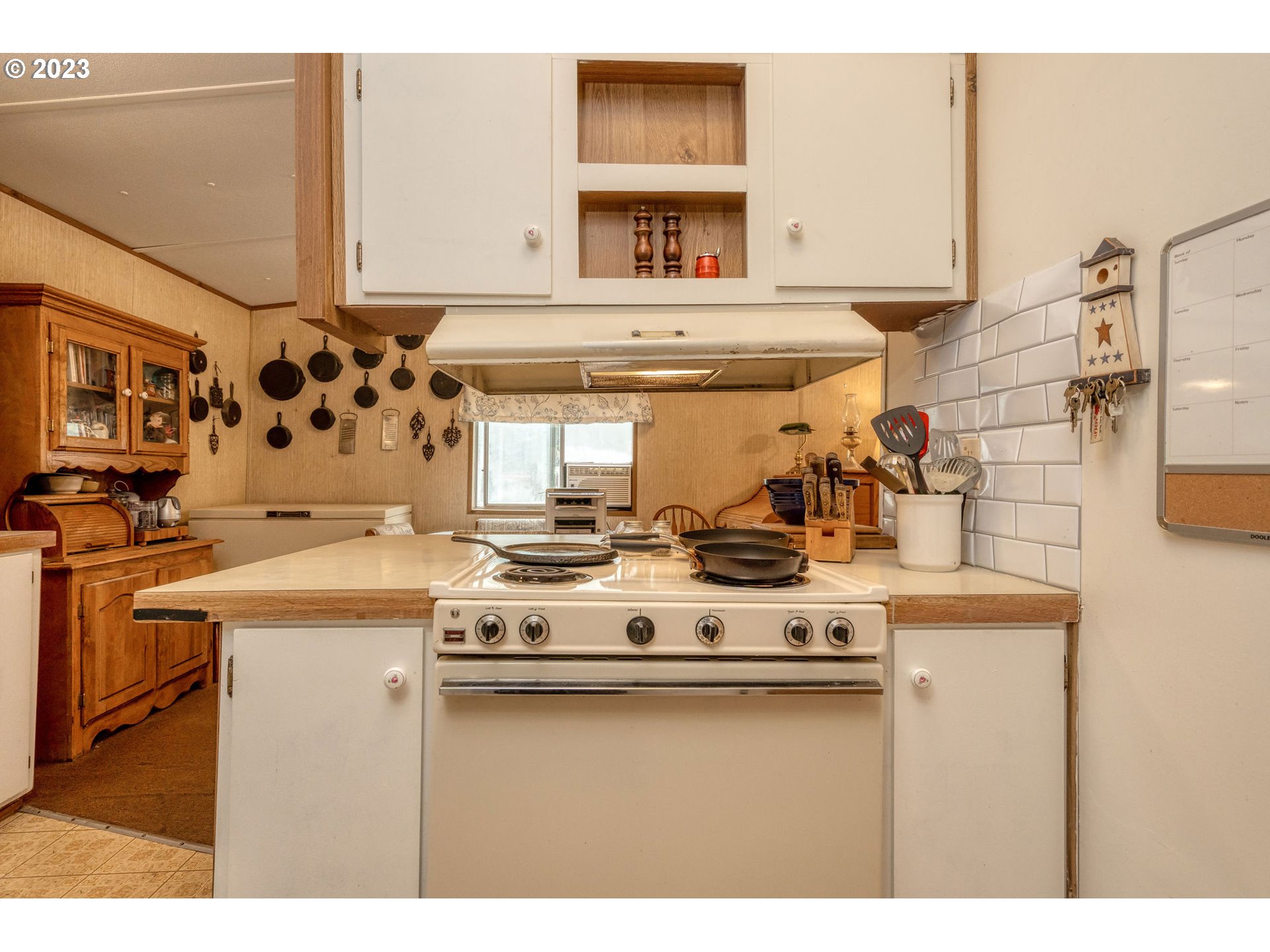 26720 Northwest Williams Canyon Road Gaston, OR 97119 - Photo 22 of 33 a kitchen with a stove and a white cabinet
