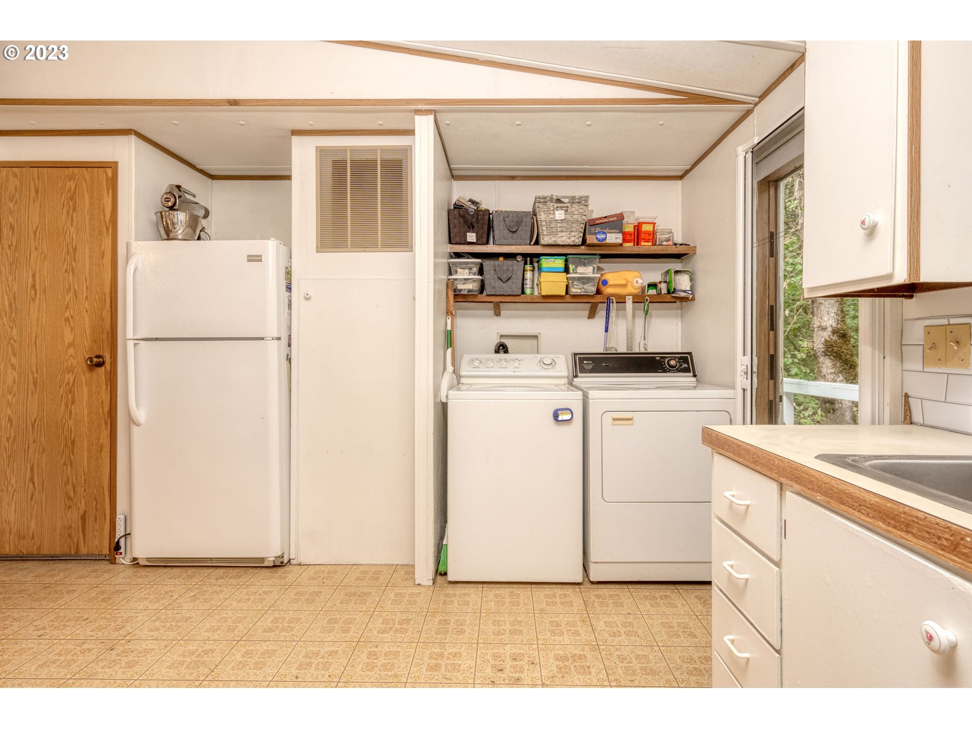 26720 Northwest Williams Canyon Road Gaston, OR 97119 - Photo 23 of 33 a kitchen with white cabinets and white appliances