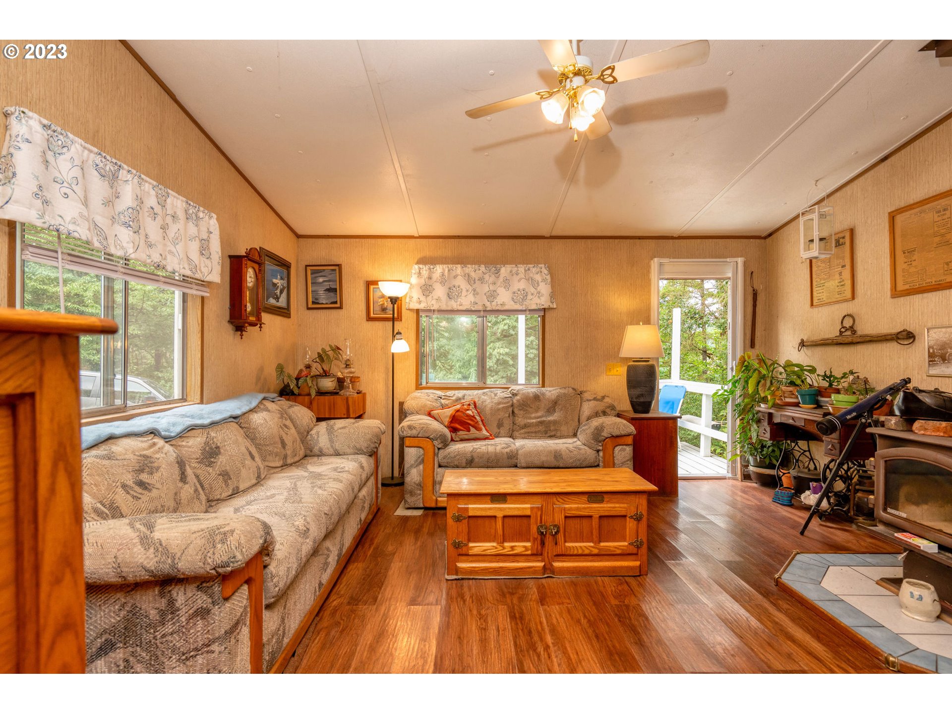 26720 Northwest Williams Canyon Road Gaston, OR 97119 - Photo 25 of 33 a living room with furniture a chandelier and a large window