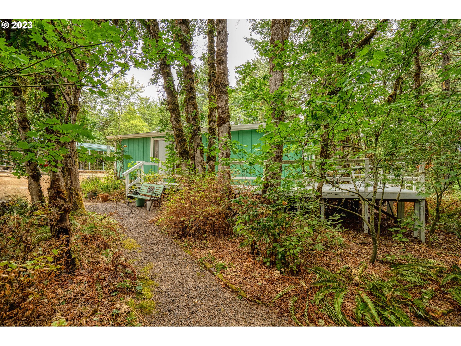 26720 Northwest Williams Canyon Road Gaston, OR 97119 - Photo 9 of 33 a backyard of a house with table and chairs
