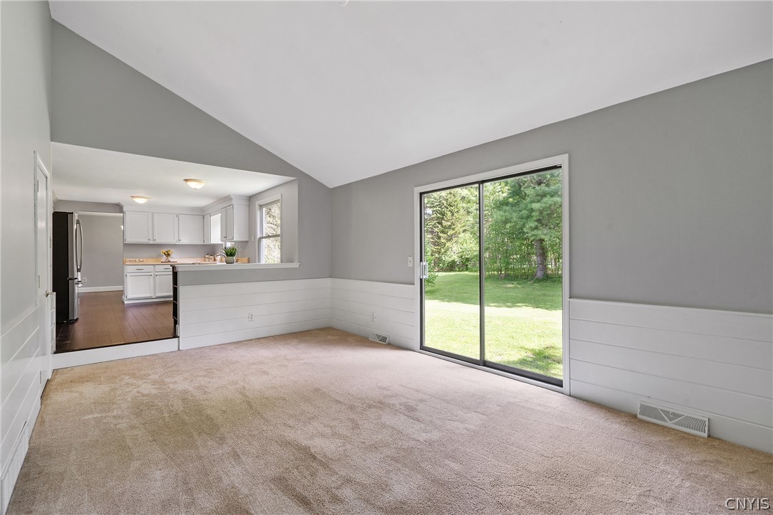 8841 Wandering Way Lysander, NY 13027 - Photo 20 of 42 Slider from family room leads out to the private wooded lot.