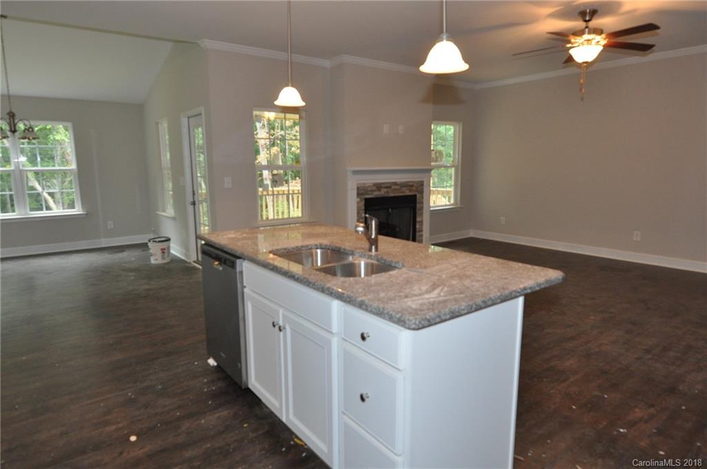 4081 Ruston Creek Road, Unit 83 Catawba, SC 29704 - Photo 27 of 27 a kitchen with a sink chandelier and wooden floor
