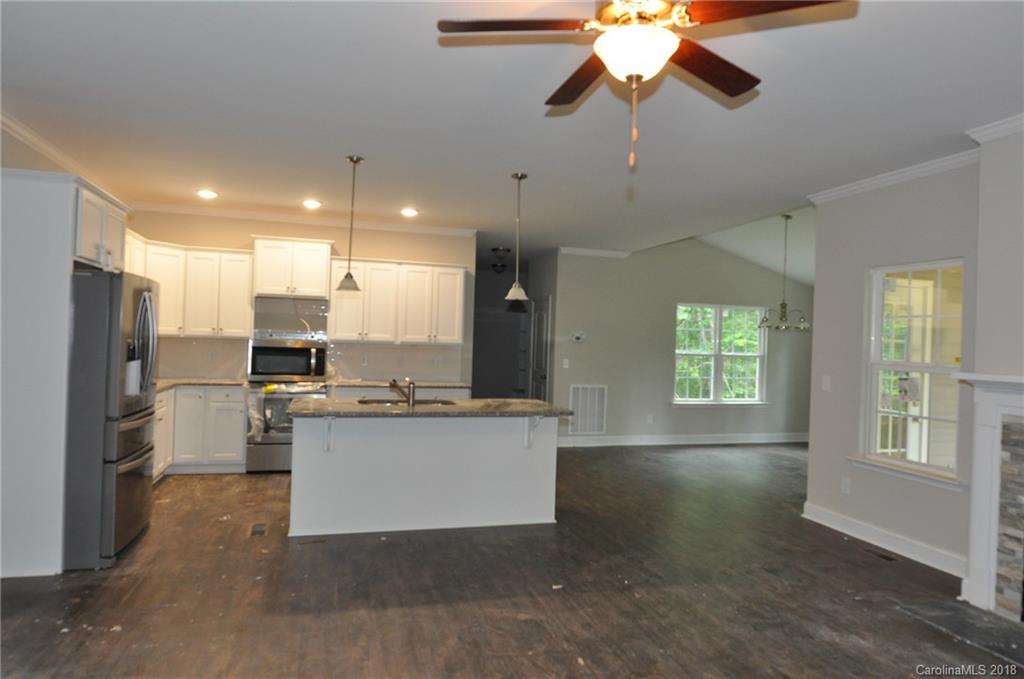 4081 Ruston Creek Road, Unit 83 Catawba, SC 29704 - Photo 6 of 27 a kitchen with stainless steel appliances granite countertop a sink a stove and a refrigerator