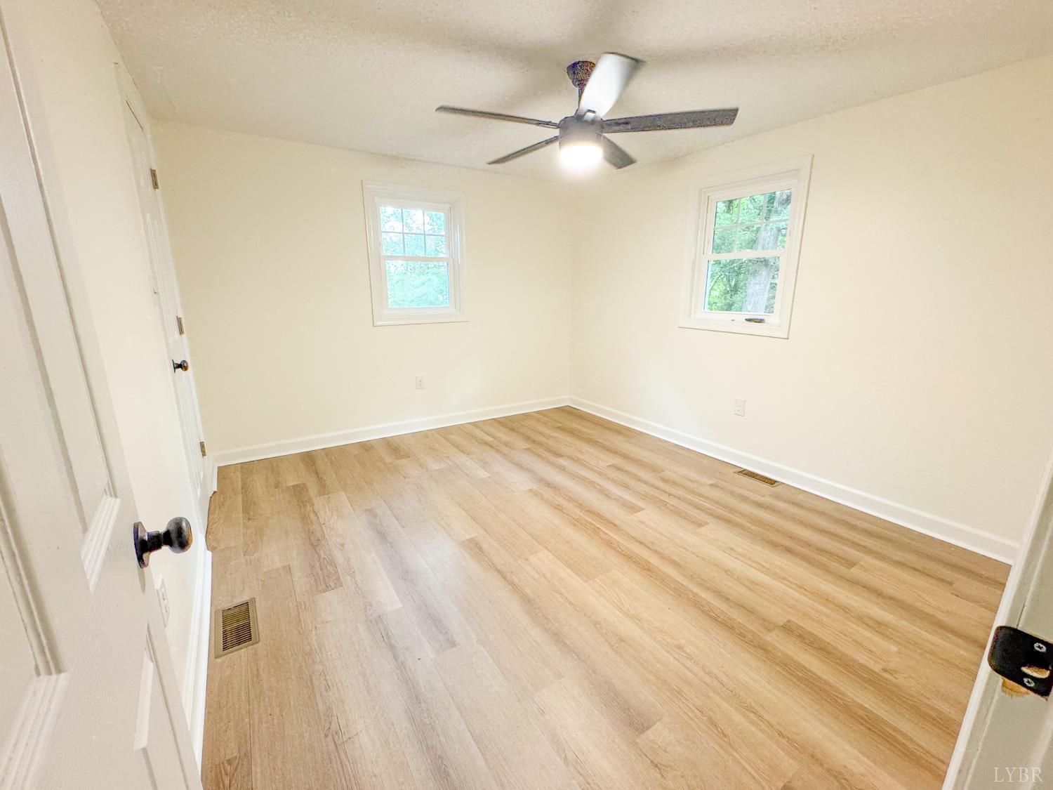 684 East Ferry Road Gladys, VA 24554 - Photo 14 of 20 a view of a big room with wooden floor and windows