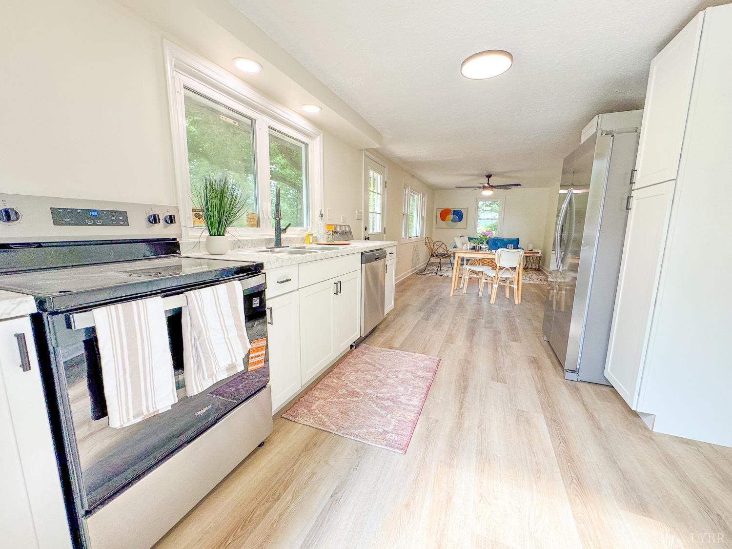 684 East Ferry Road Gladys, VA 24554 - Photo 6 of 20 a kitchen with wooden floors and white walls
