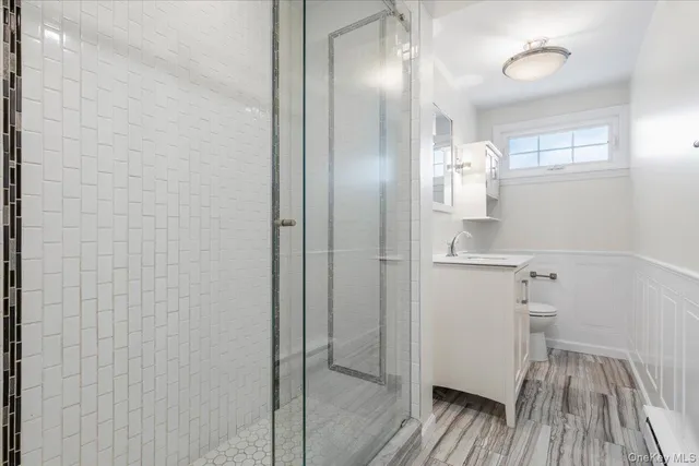 a bathroom with a sink and glass door shower