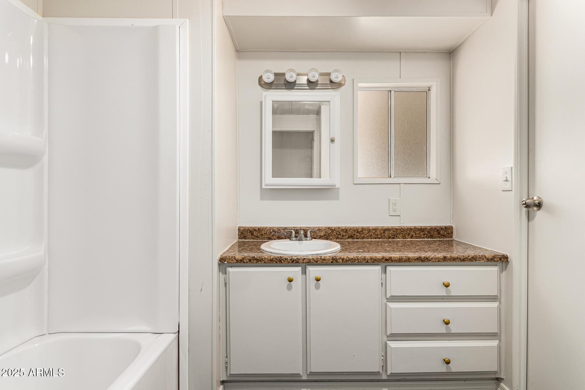 2945 West 9th Place Apache Junction, AZ 85120 - Photo 16 of 23 a bathroom with a sink and a mirror