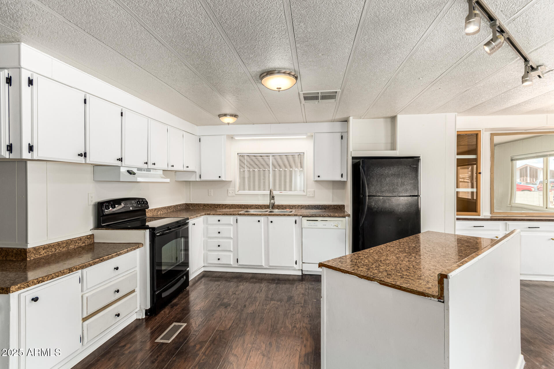 2945 West 9th Place Apache Junction, AZ 85120 - Photo 6 of 23 a kitchen with granite countertop white cabinets and stainless steel appliances