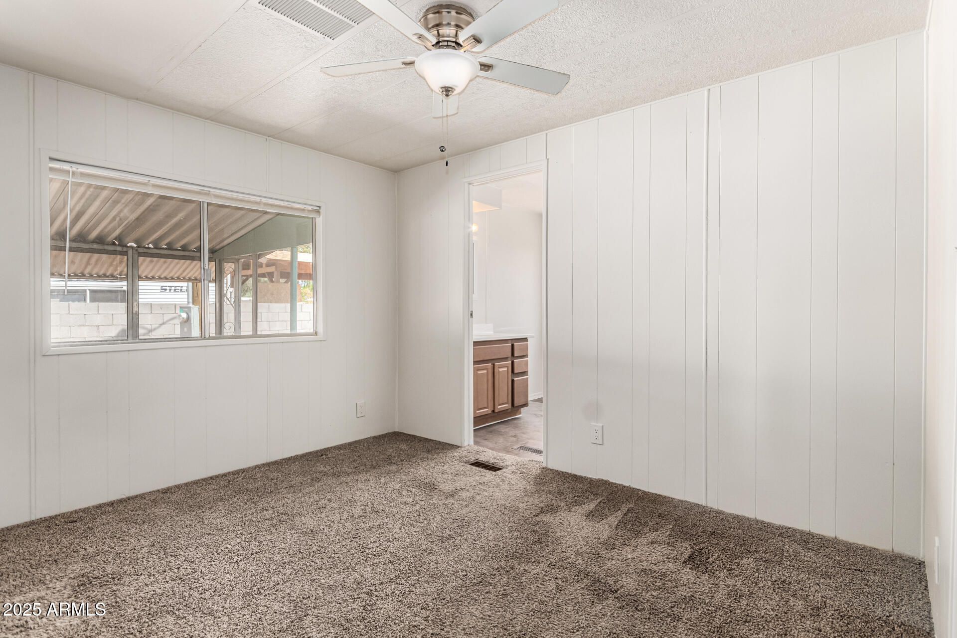 2945 West 9th Place Apache Junction, AZ 85120 - Photo 9 of 23 a view of an empty room with a window