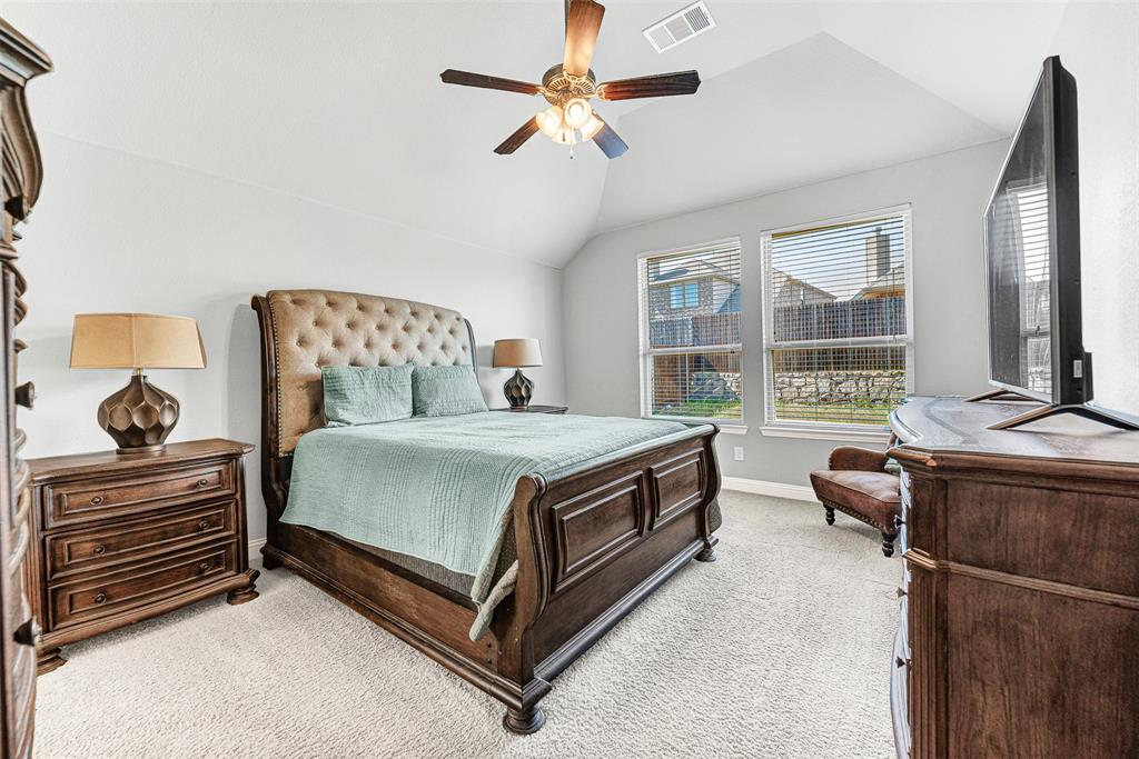 1313 Torrington Lane Forney, TX 75126 - Photo 10 of 21 a bedroom with a bed and a chandelier