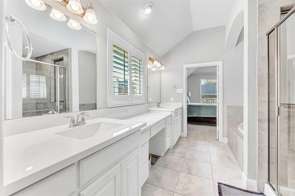 1313 Torrington Lane Forney, TX 75126 - Photo 11 of 21 a bathroom with a granite countertop sink a large mirror and a bathtub