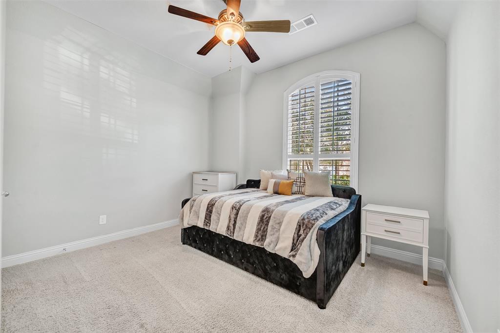 1313 Torrington Lane Forney, TX 75126 - Photo 13 of 21 a spacious bedroom with a bed and a window