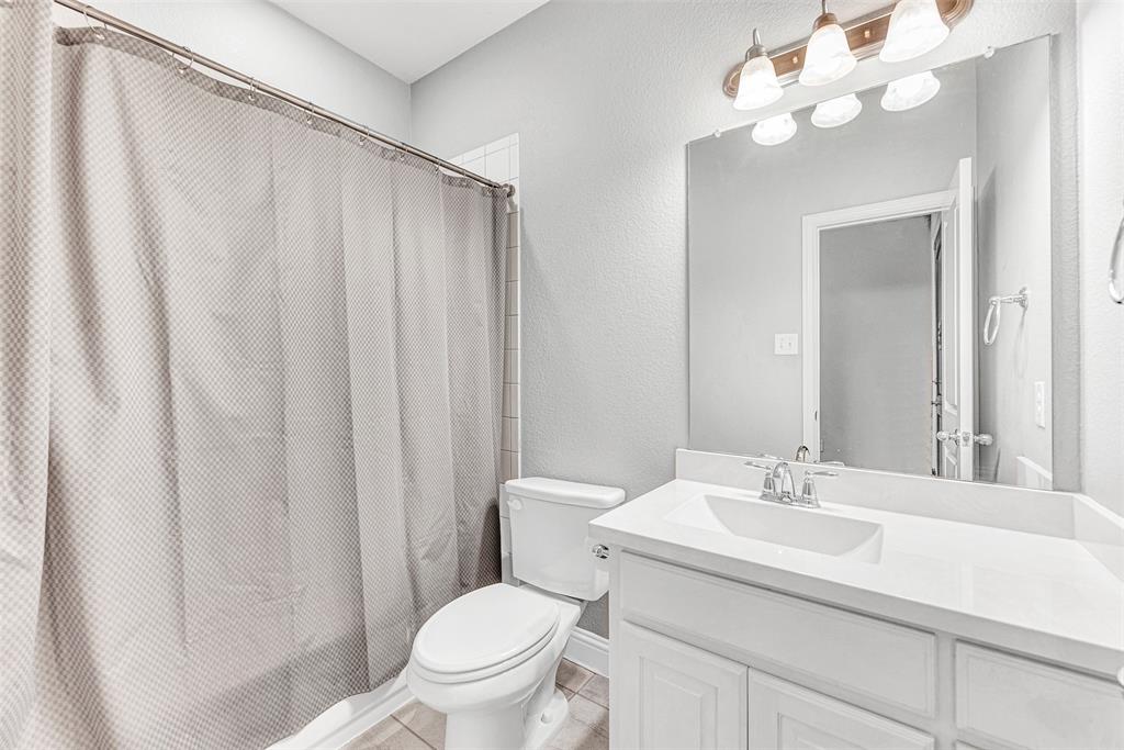 1313 Torrington Lane Forney, TX 75126 - Photo 14 of 21 a bathroom with a sink vanity mirror and toilet