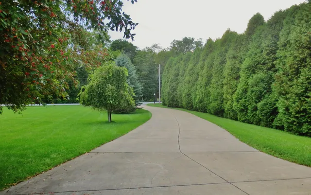 a front view of a house with a garden and plants