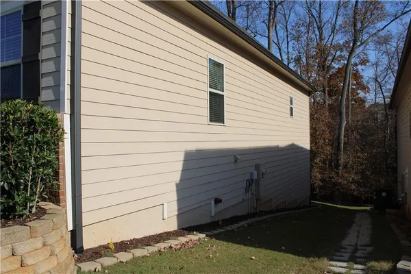 a view of a house with a wooden fence