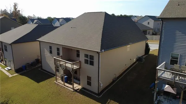 an aerial view of a house with wooden fence