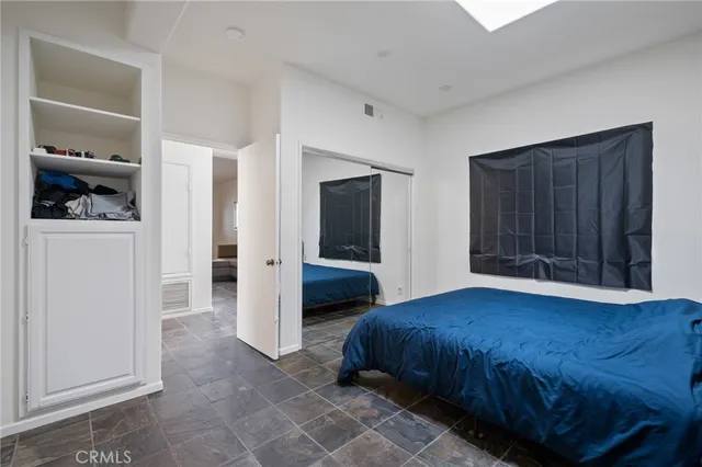 a bedroom with a bed and a closet