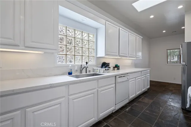 a kitchen with stainless steel appliances a stove a sink and cabinets