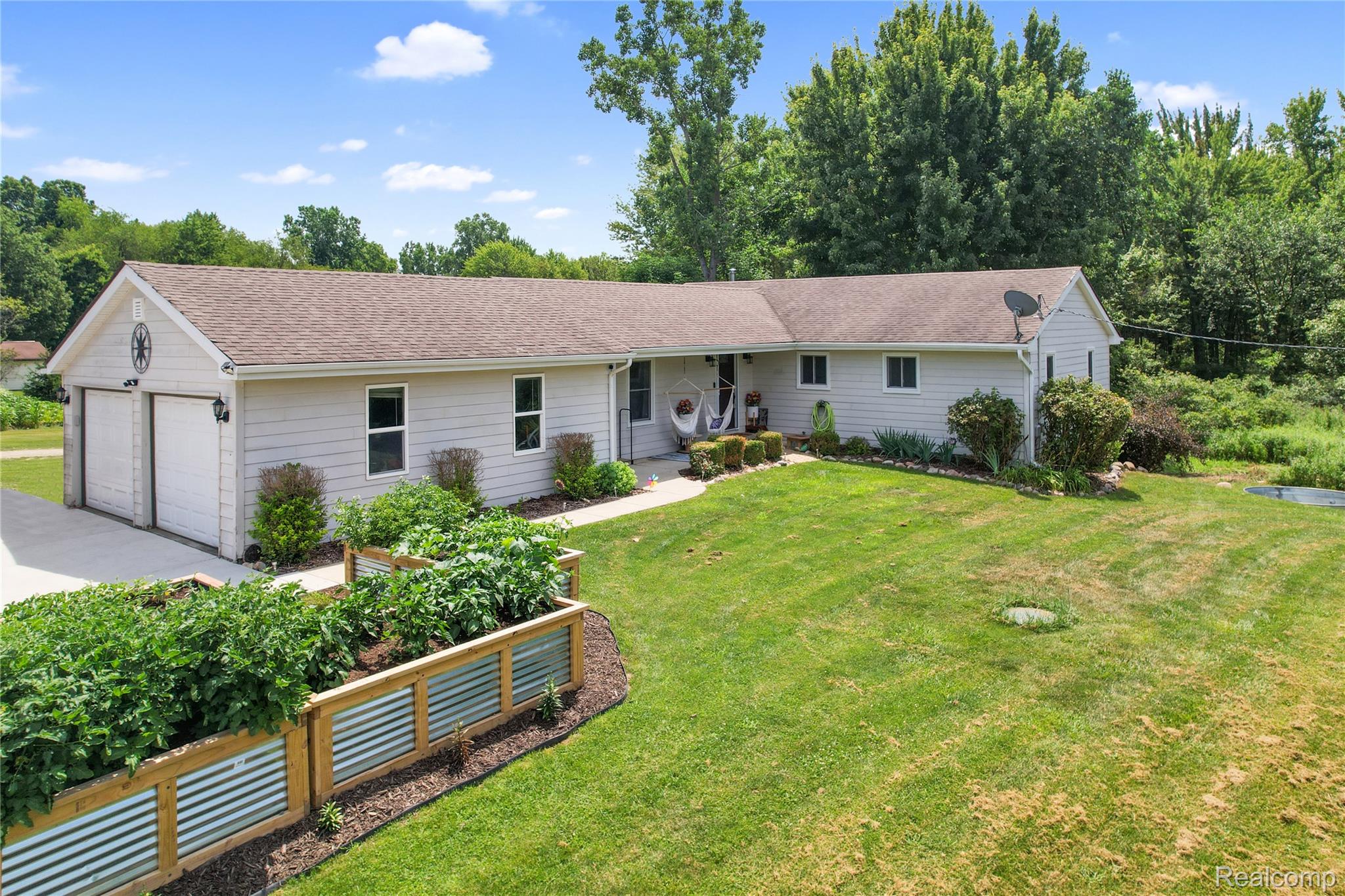 6050 Brophy Road Howell, MI 48855 - Photo 23 of 27 Light-colored siding exterior with a brown shingle roof