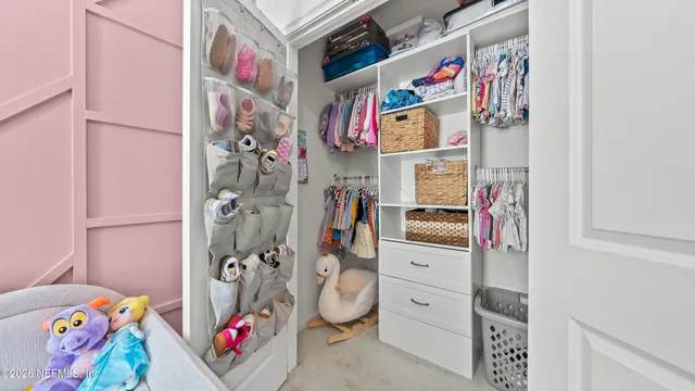 a living room with furniture and a baby crib