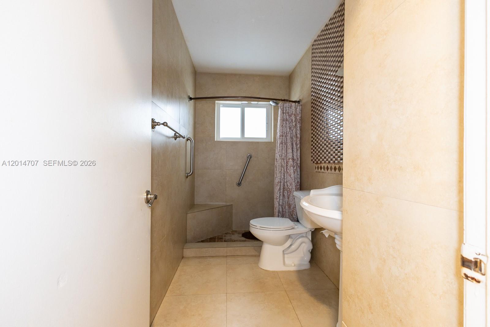 14452 Southwest 115th Street Miami, FL 33186 - Photo 13 of 17 a bathroom with a toilet and a shower