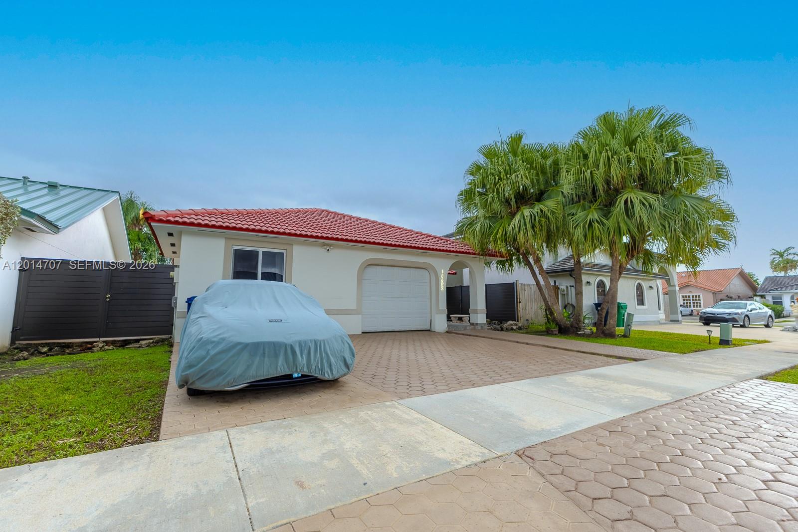14452 Southwest 115th Street Miami, FL 33186 - Photo 15 of 17 a house view with a garden space
